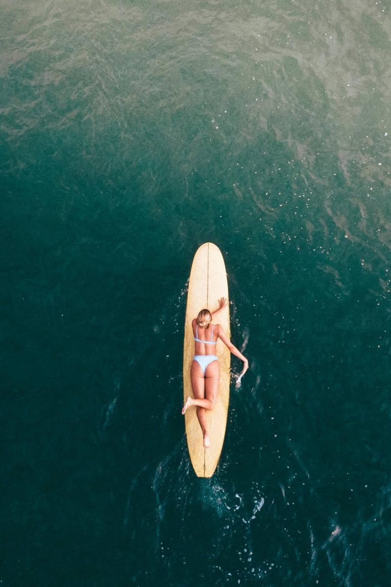 Woman surfing in Santa Teresa, Costa Rica, aerial ocean view