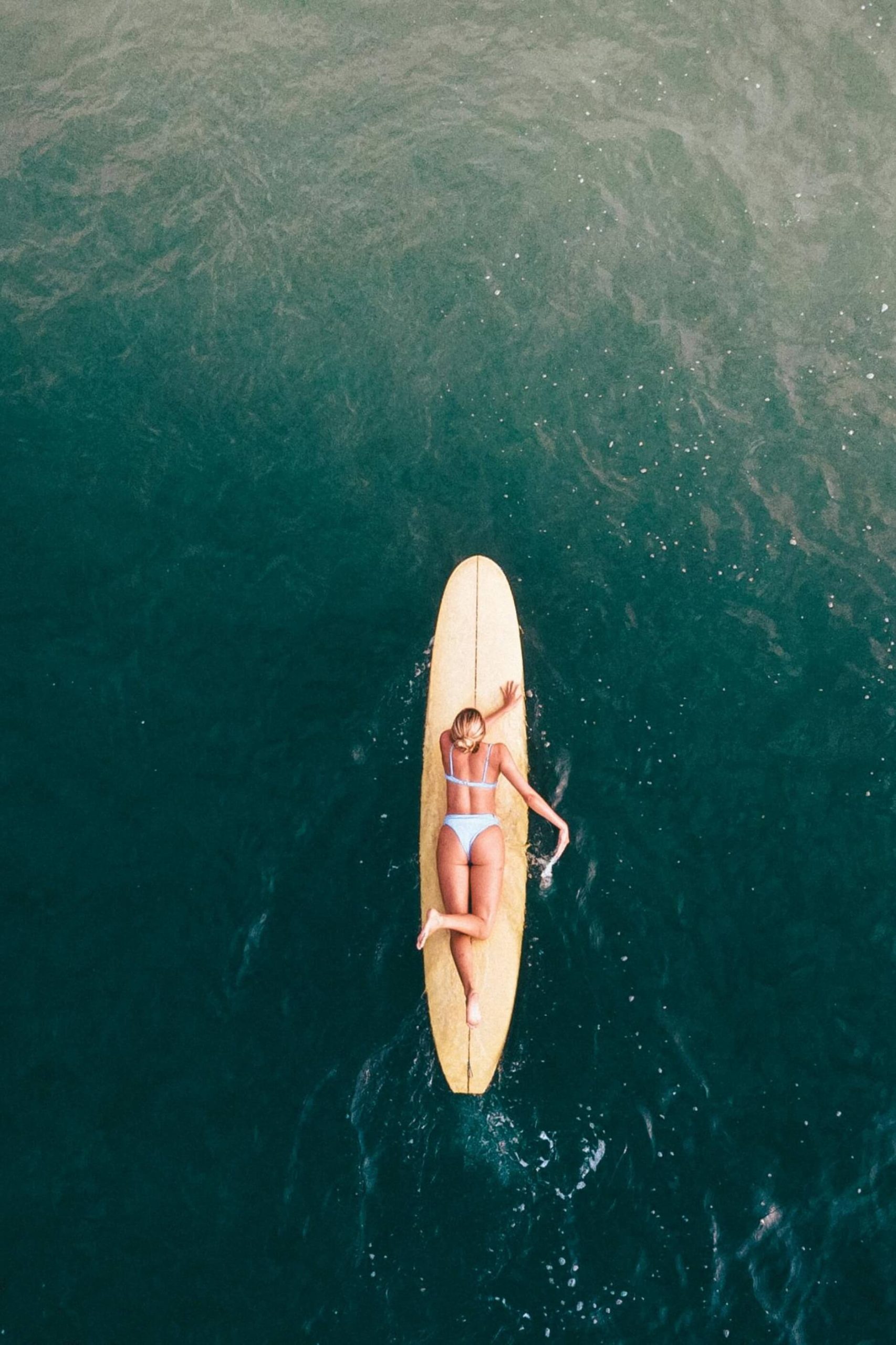 Woman surfing in Santa Teresa, Costa Rica, aerial ocean view